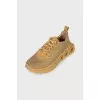 Golden sneakers with a figured sole