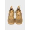 Golden sneakers with a figured sole