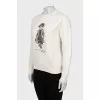 White sweatshirt with branded print and tag