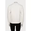 White sweatshirt with branded print and tag