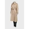 Beige trench coat with buckles