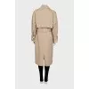Beige trench coat with buckles