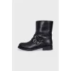 Leather boots decorated with straps