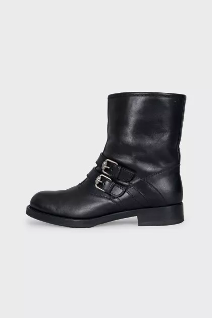 Leather boots decorated with straps