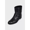 Leather boots decorated with straps