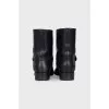 Leather boots decorated with straps