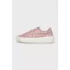 Pink sneakers with a signature print
