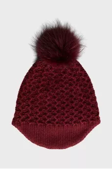 Red knitted hat with a pompom