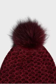 Red knitted hat with a pompom