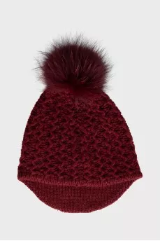 Red knitted hat with a pompom