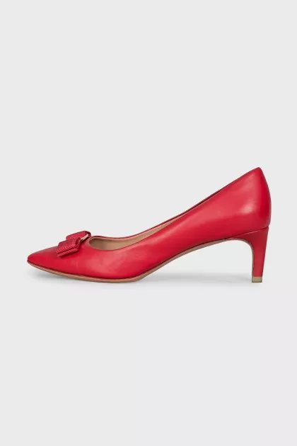 Red leather shoes decorated with a bow