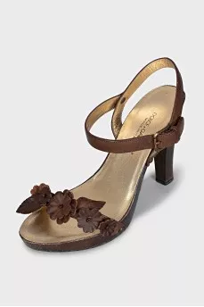 Brown sandals decorated with flowers