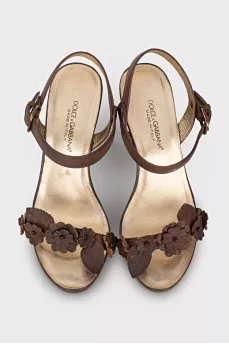 Brown sandals decorated with flowers