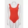 One-piece swimsuit with open back and tag