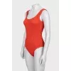 One-piece swimsuit with open back and tag