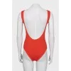 One-piece swimsuit with open back and tag