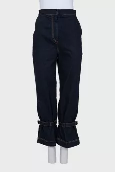 Dark blue jeans decorated with straps