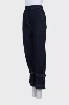 Dark blue jeans decorated with straps