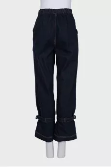 Dark blue jeans decorated with straps