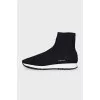Black textile sneakers with a white sole