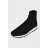 Black textile sneakers with a white sole