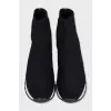 Black textile sneakers with a white sole