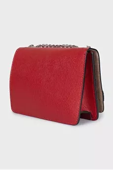 The red bag is decorated with a strap