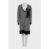 Striped dress decorated with a brooch