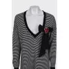 Striped dress decorated with a brooch