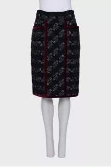 A suit consisting of a jacket and skirt with velvet trim
