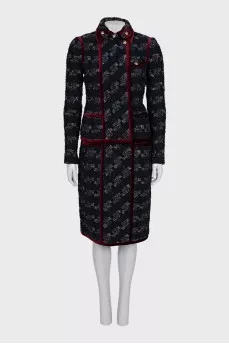 A suit consisting of a jacket and skirt with velvet trim