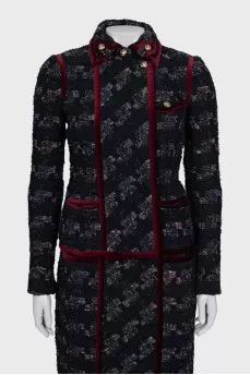 A suit consisting of a jacket and skirt with velvet trim