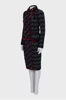A suit consisting of a jacket and skirt with velvet trim