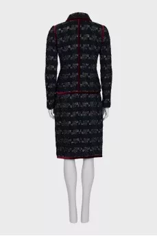 A suit consisting of a jacket and skirt with velvet trim
