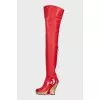 Leather over-the-knee boots with a gold wedge heel