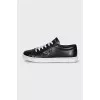 Black sneakers with a silver logo