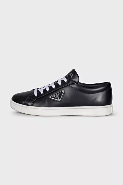 Black sneakers with a silver logo