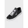 Black sneakers with a silver logo