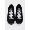 Black sneakers with a silver logo