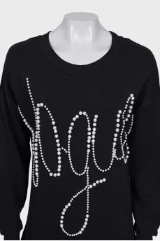 Dress decorated with beads and pleated hem