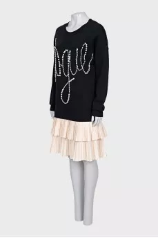 Dress decorated with beads and pleated hem