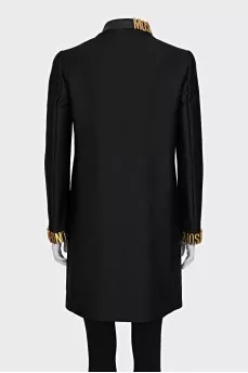 The black coat is decorated with a golden logo.