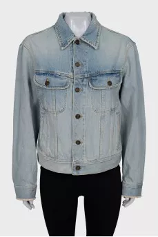 Distressed denim jacket with tag