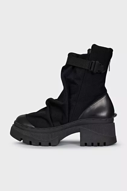 Textile and leather boots decorated with straps