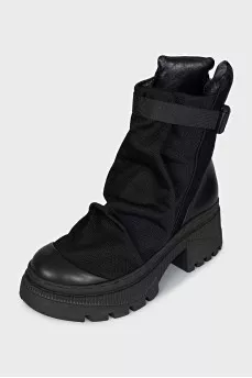 Textile and leather boots decorated with straps