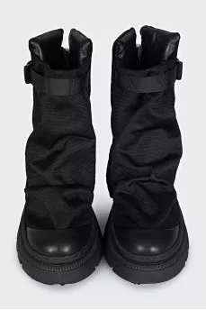 Textile and leather boots decorated with straps