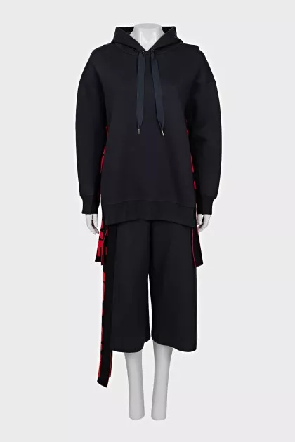 A suit of a hoodie and cropped trousers