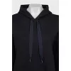 A suit of a hoodie and cropped trousers