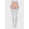 Pink denim shorts with buttons