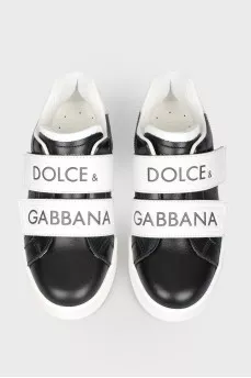 Black children's sneakers with velcro with a tag